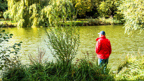 Rear view of boy standing in lake