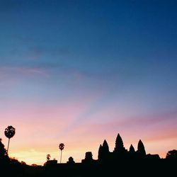 Silhouette of trees against sky at sunset