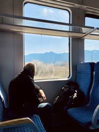 Rear view of man sitting in car