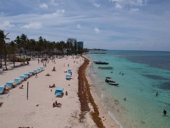 People on beach against sky