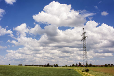 Scenic view of agricultural field against sky with beautiful clouds
