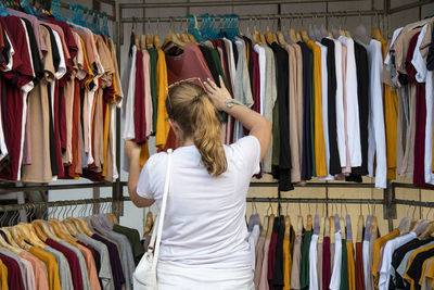 Rear view of woman standing at store