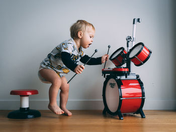 Kid playing his drum set