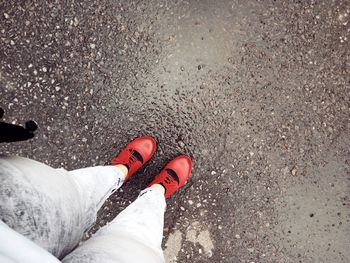 Low section of person standing on footpath