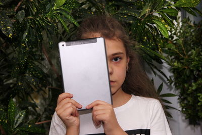 Portrait of a girl holding paper with text