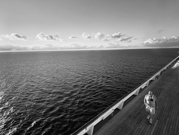 Man looking at sea against sky