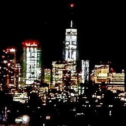 Low angle view of illuminated buildings against sky at night