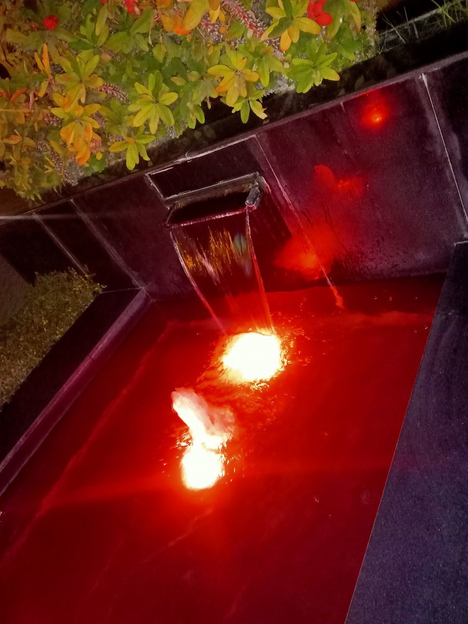 HIGH ANGLE VIEW OF ILLUMINATED FIRE IN WATER