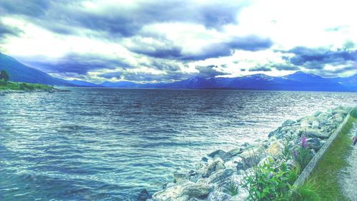 Scenic view of sea against cloudy sky