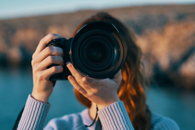 Portrait of woman photographing