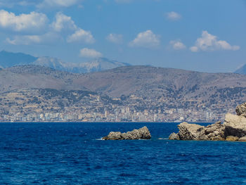 Scenic view of sea and mountain against sky