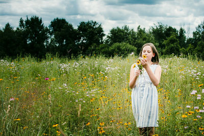 Girl picking wild flowers in a southen michigan field