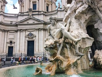 Statue and fountain on street