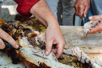 High angle view of people cooking meat 