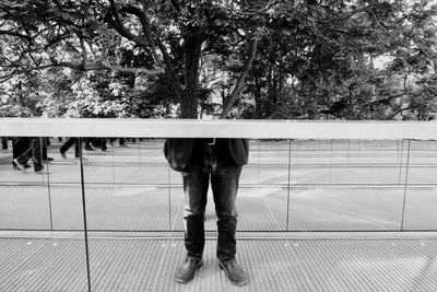 Man standing against tree