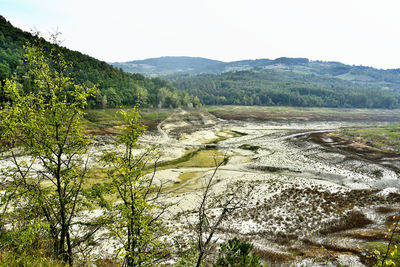 Scenic view of river and mountains against sky