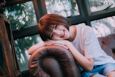 Portrait of smiling girl sitting on floor