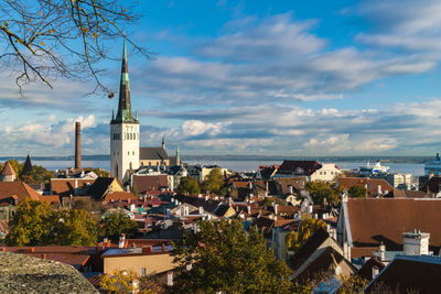 View of the old town with st olaf's church tower and the baltic sea