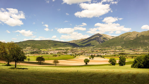 Scenic view of golf course against sky