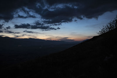 Scenic view of silhouette land against sky at sunset