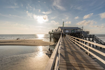 Pier over sea against sky