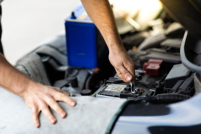 Midsection of man working in car