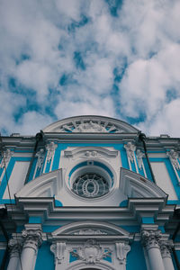 Low angle view of building against cloudy sky