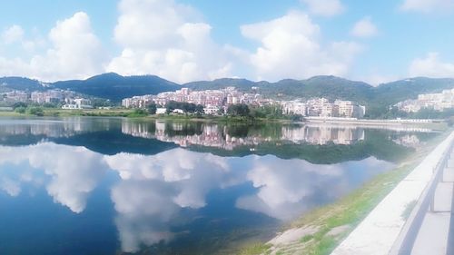 Calm lake with mountain range in background