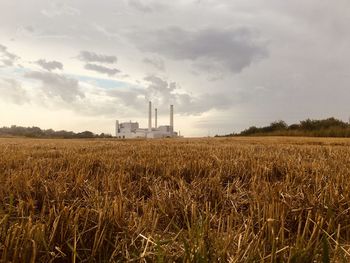 Scenic view of pover plant and agricultural field against sky