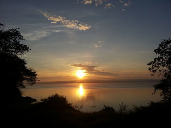 Scenic view of lake against sky during sunset