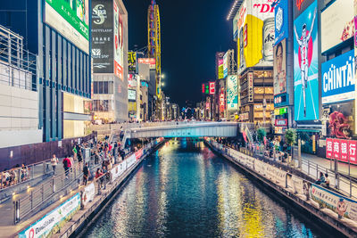 Illuminated buildings in the city canel at osaka night