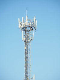 Low angle view of communications tower against clear sky