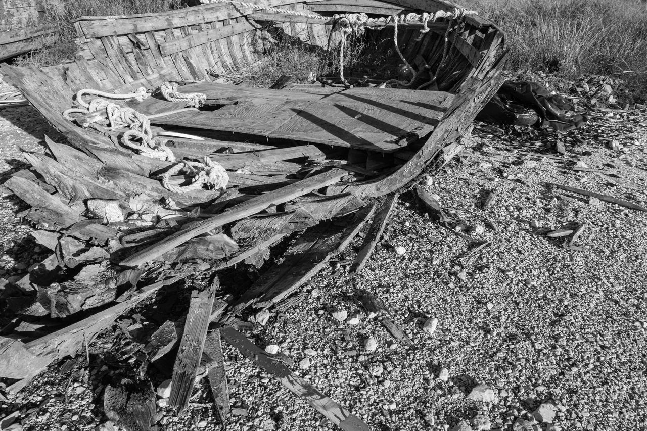 track, black and white, day, damaged, abandoned, high angle view, nature, no people, land, monochrome photography, monochrome, wood, transportation, rundown, field, vehicle, outdoors, deterioration, decline, sunlight, old, mode of transportation, plant, broken, bad condition, weathered, beach