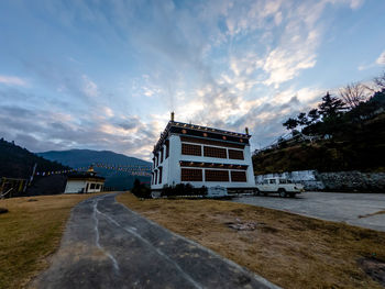 Building by road against sky