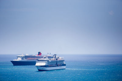 Ship sailing on sea against clear sky