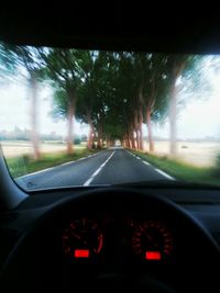 View of road seen through car windshield