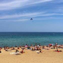 People on beach against sky