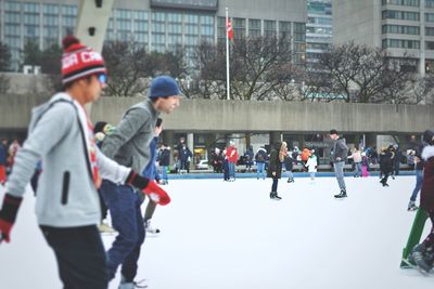 People on snow in city