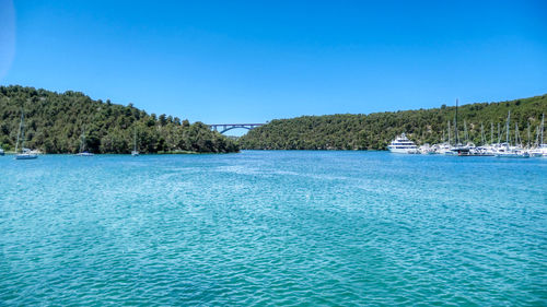 Scenic view of skradin lake against clear blue sky