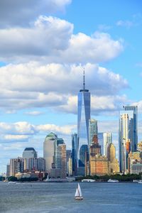 View of buildings in city against cloudy sky