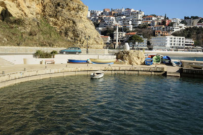 Boats in river with buildings in background
