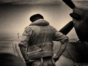 Low angle view of woman standing against sky