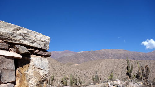 Scenic view of rocky mountains against clear blue sky