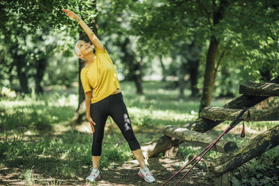 Senior woman stretching after a outdoor walking exercise
