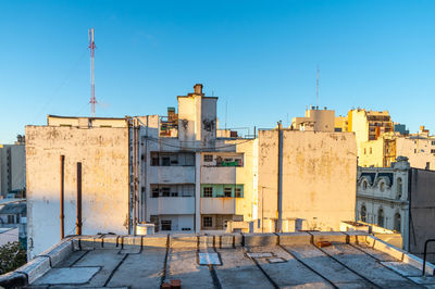 Buildings against clear blue sky