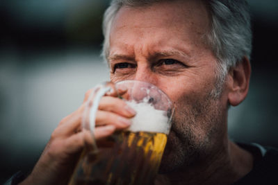 Close-up of mature man drinking beer