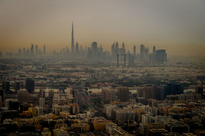 High angle view of city buildings against sky