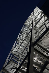 Low angle view of modern building against sky at night