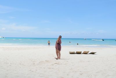 Rear view of woman standing on beach