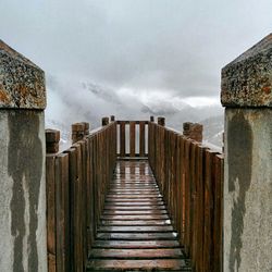 View of wooden structure against cloudy sky